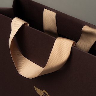 Grosgrain ribbon handle inserted into top fold area